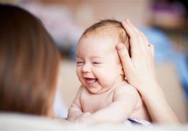 When should a preemie start smiling?
